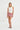 white tank top with studded neckline and mini skirt with red-and-white hawaiian print