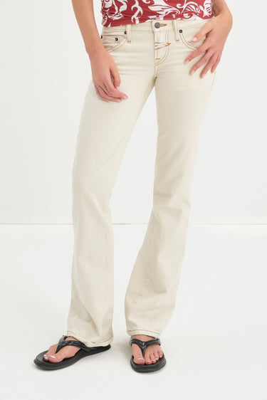Person wearing white jeans on a white background