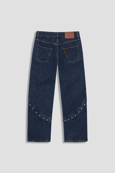 dark wash jean with stud details at hip and midcalf