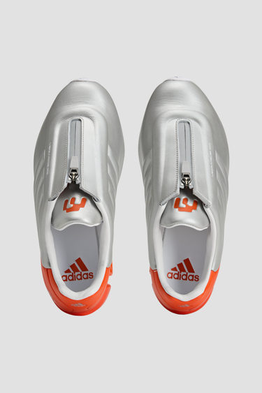 silver and orange adidas shoe with white sole and tongue zipper