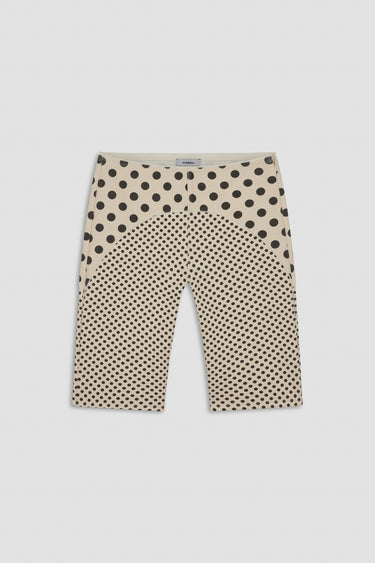nude capri pants with black polka dot pattern on a white background