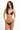 Woman wearing a black bikini with embellishments on a white background