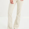 Person wearing white jeans on a white background
