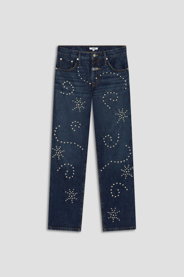 Blue jeans with decorative studs on a light gray background