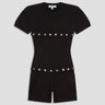 black shortsleeve knit romper with mother of pearl buttons at bust and waist