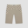 nude capri pants with black polka dot pattern on a white background