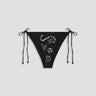 Black bikini bottom with embellishments on a light gray background